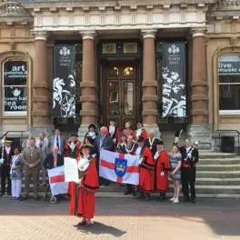 Suffolk Mayors holding Suffolk flags on the steps of the Town Hall in Ipswich